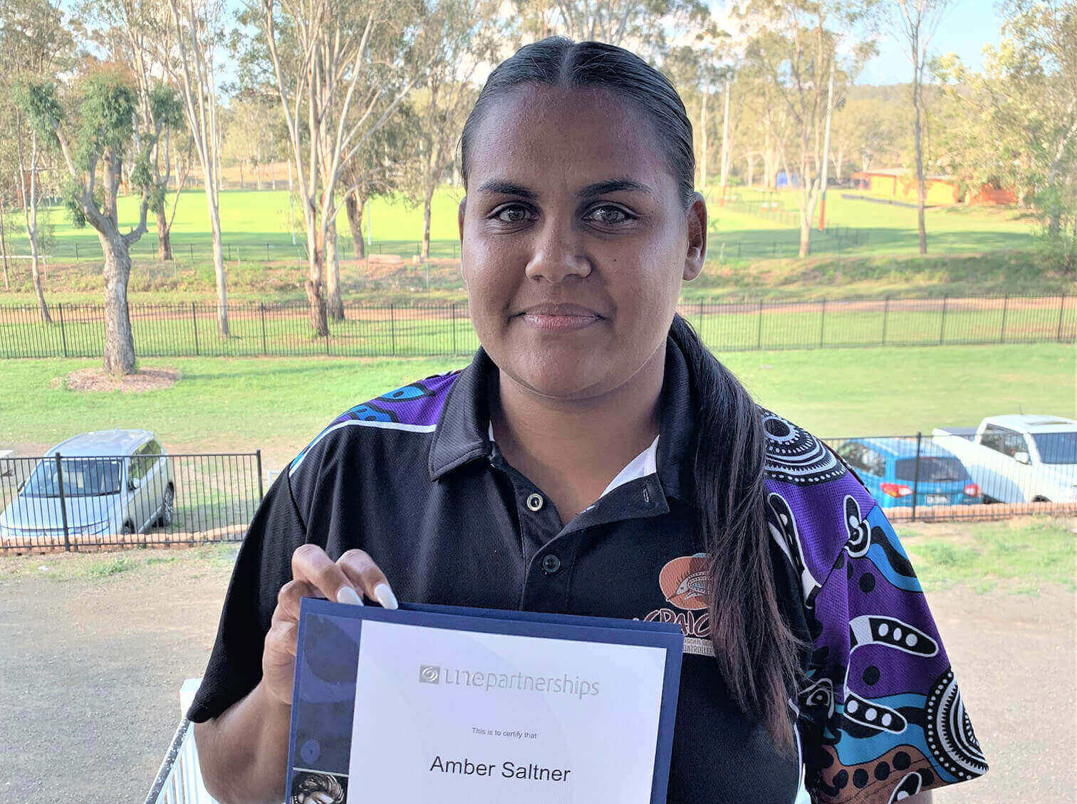 Graduate holding her Diploma.